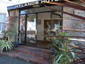 a front entrance to a building with plants at Hylands Hotel Double Room with Shared Bathroom & Free Parking in Nottingham +6 photos