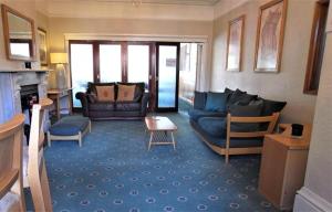 a living room with a couch and a fireplace at Hylands Hotel Double Room with Shared Bathroom & Free Parking in Nottingham