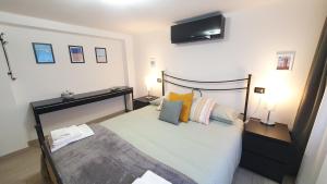 a bedroom with a bed with a television on the wall at Verrazzano Family in Lido di Classe