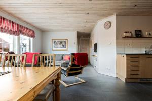 a kitchen and living room with a table and chairs at Blåstöten Osthang - Ramundberget in Bruksvallarna +37 photos