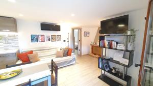 a living room with a couch and a tv at Verrazzano Family in Lido di Classe