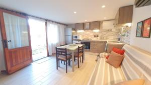 a kitchen with a table and chairs in a room at Verrazzano Family in Lido di Classe