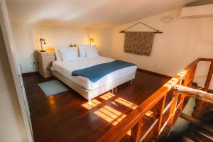 a bedroom with a bed and a wooden floor at Casa do Alto in Vilamoura +65 photos