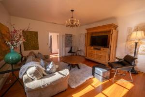 a living room with a couch and a tv at Historic Loft Two 01 in Carson City