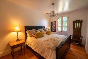 a bedroom with a large bed and a chandelier at Historic Loft Two 01 in Carson City