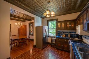a kitchen with a refrigerator and a table in it at Historic Loft Two 01 in Carson City