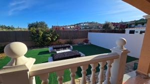 a balcony with a yard with a golf course at Chalet Kabesa Peñiscola in Peniscola