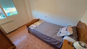 a bedroom with a bed with pillows on it at Chalet Kabesa Peñiscola in Peniscola