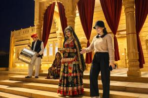 a man and a woman standing on the stage at Desert Popular Resort & Camp in Jaisalmer