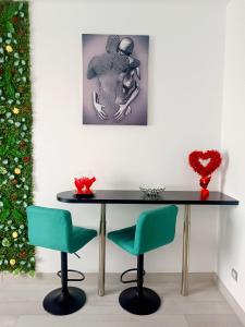 a table and two chairs and a christmas tree at Eduard Elegance Rin Studios in Bucharest