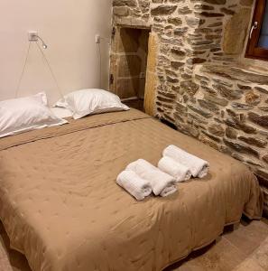 a bed in a room with two towels on it at la grange d'Eugenie in Estaing