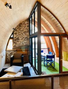a room with a large window and a table at la grange d'Eugenie in Estaing