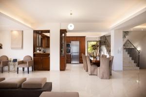 a kitchen and dining room with a table and chairs at Villa Rosemary - Luxury Nature Escape in Roussospítion