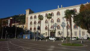 a large white building with a clock tower on top of it at B&B Centrale in Salerno