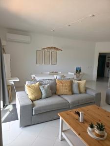 a living room with a couch and a table at Albur Beach House in Alvor +29 photos