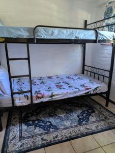 a couple of bunk beds with a mattress on them at Carravensiria Chalet 27 in Hibberdene