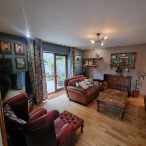 a living room with a couch and a table at Calderbrook House in Hebden Bridge