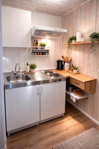 a kitchen with white cabinets and a sink at Kristiansund Airport Motell in Kristiansund