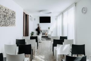 a dining room with white tables and white chairs at Arca Guest House in San Trovaso