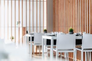 a dining room with white tables and white chairs at Arca Guest House in San Trovaso