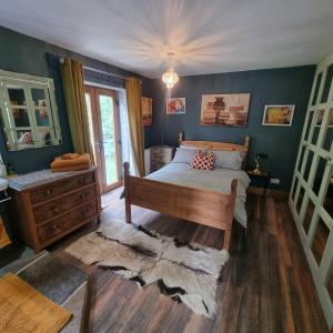 a bedroom with a bed and a dresser at Calderbrook House in Hebden Bridge