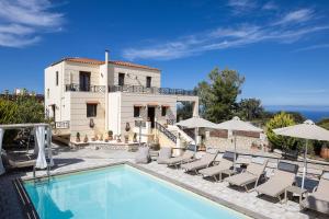 a villa with a swimming pool in front of a house at Villa Rosemary - Luxury Nature Escape in Roussospítion
