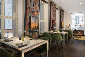a dining room with tables and green chairs at Radisson Blu Style Hotel, Vienna in Vienna