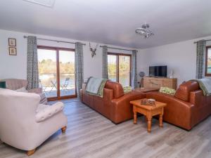a living room with two couches and a table at Star Carr Lakes in Great Driffield