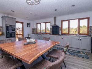 a large kitchen with a wooden table and chairs at Star Carr Lakes in Great Driffield