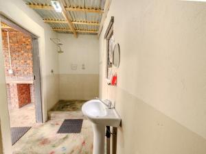a bathroom with a white sink in a room at Impala Game Ranch in Dinokeng Game Reserve