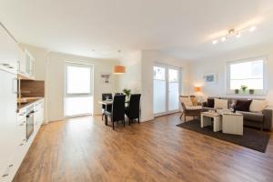 a living room with a couch and a table at Ferienwohnung Dünenhäuser App. A2 in Scharbeutz
