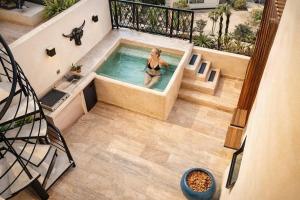 a woman in a swimming pool in a house at Casa Vibe PH- Private Rooftop - 3 Balcony - Pool in Tulum