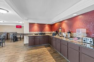 a lobby of a hotel with a breakfast bar at Red Roof Inn Ardmore in Ardmore