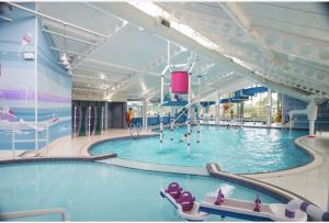 a large swimming pool in a large building at Edinburgh Lux Lodge Seton Sands in Port Seton