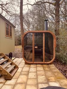 a large glass window sitting on a patio at Dreamers Hut in Dipton