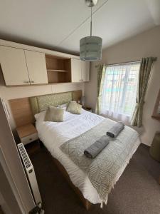 a bedroom with a bed with two pillows on it at Sunshine Newquay Bay Resort in Newquay Bay Resort +13 photos