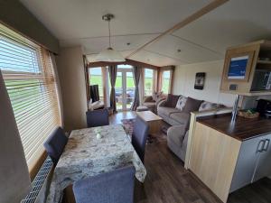 a living room with a table and a couch at Paddock view in Pembrokeshire