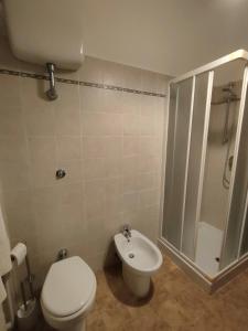 a bathroom with a toilet and a shower and a sink at I Tre Archi in Suvereto +4 photos