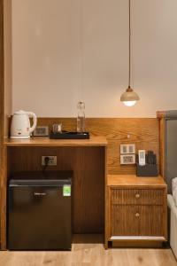 a kitchen with a black dishwasher next to a counter at Home en Lagom in Hanoi