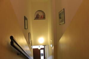 a hallway with a staircase with pictures on the wall at Alice Affittacamere in Cesana Torinese