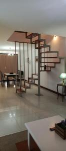 a room with a staircase and a table and chairs at Departamento duplex in Concordia