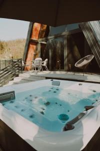 a hot tub in the middle of a house at A frame CHILL House in Brasina