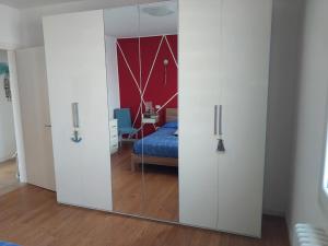 a sliding glass door in a bedroom with a bed at A 2 passi dal mare in Scardovari +19 photos