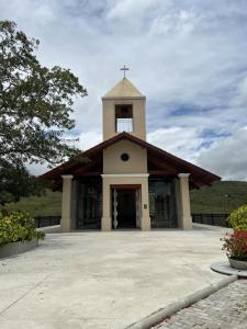 a church with a cross on top of it at Flat on Mount Castelo Sairé in Sairé