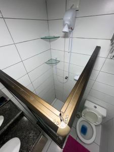 a shower stall in a bathroom with a toilet at Flat on Mount Castelo Sairé in Sairé