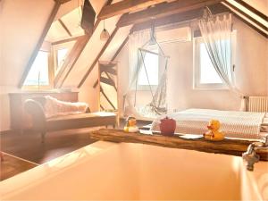 a bathroom with a bed and two rubber ducks in a tub at Viktória Inn Tihany in Tihany