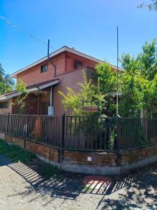 a house with a fence in front of it at EL ROBLE 2 CHILLaN in Chillán