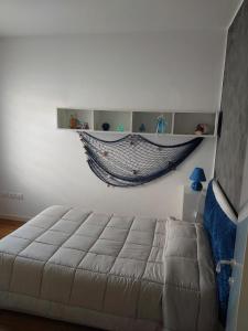 a bedroom with a hammock hanging on the wall at A 2 passi dal mare in Scardovari