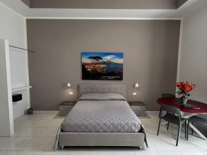 a bedroom with a bed and a red table at Vesuvian Tales in San Giorgio a Cremano
