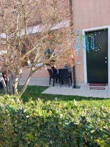 a door to a building with a table and chairs at A 2 passi dal mare in Scardovari